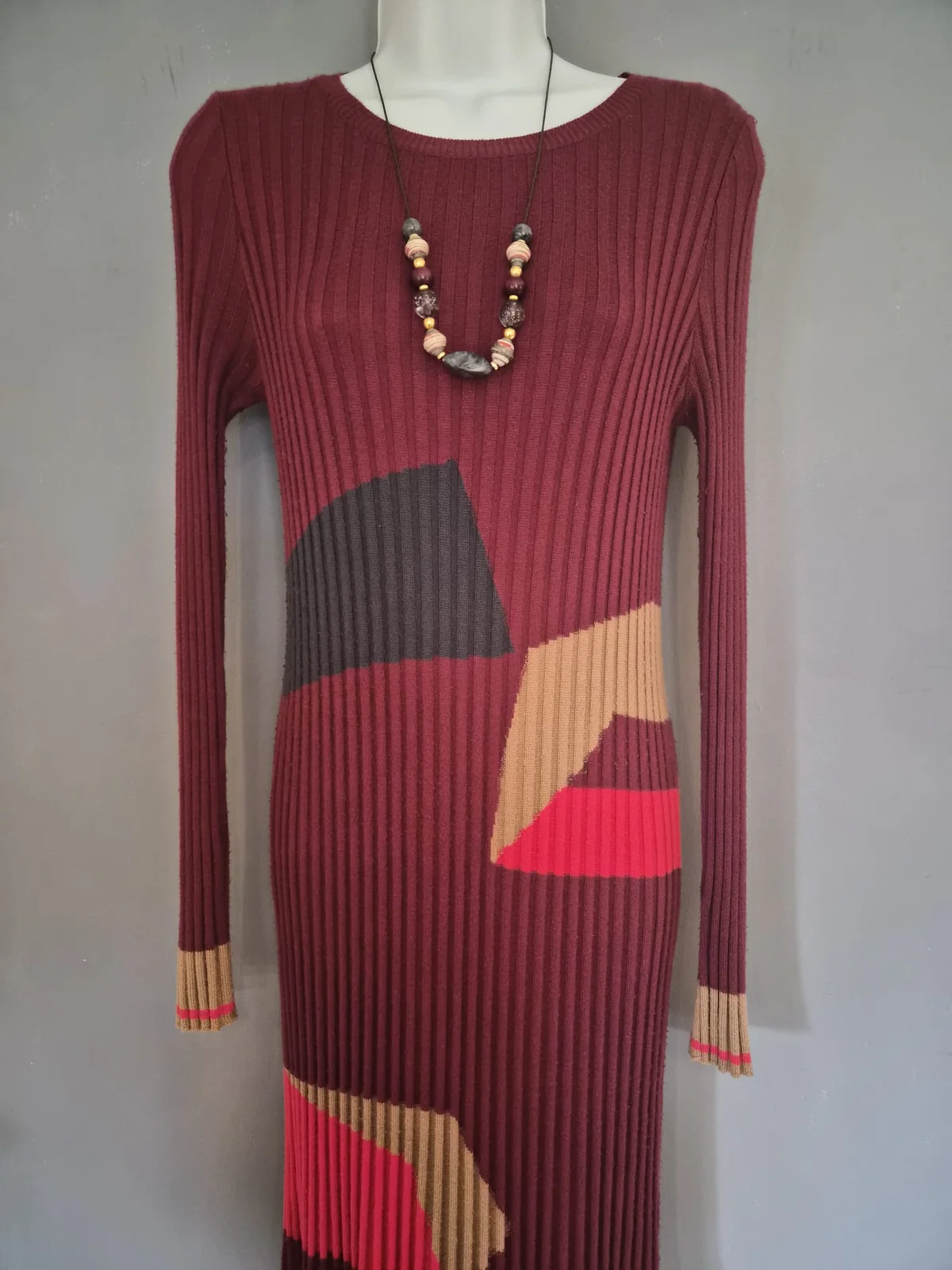 The finished necklace worn with the complete wine-coloured dress