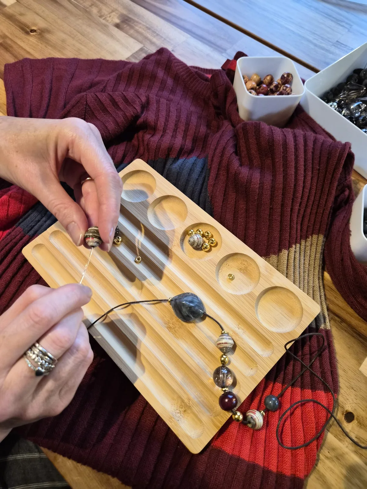 Jen working by hand with necklace components on the original dress